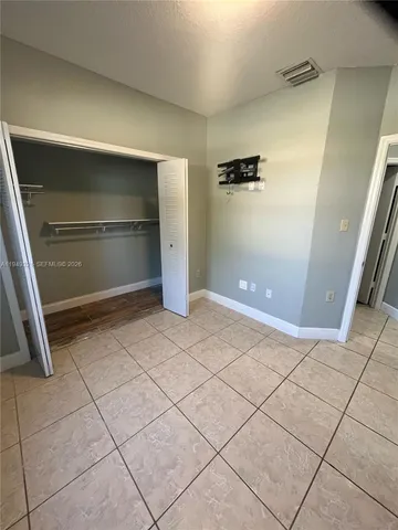 a bathroom with a granite countertop toilet sink and mirror
