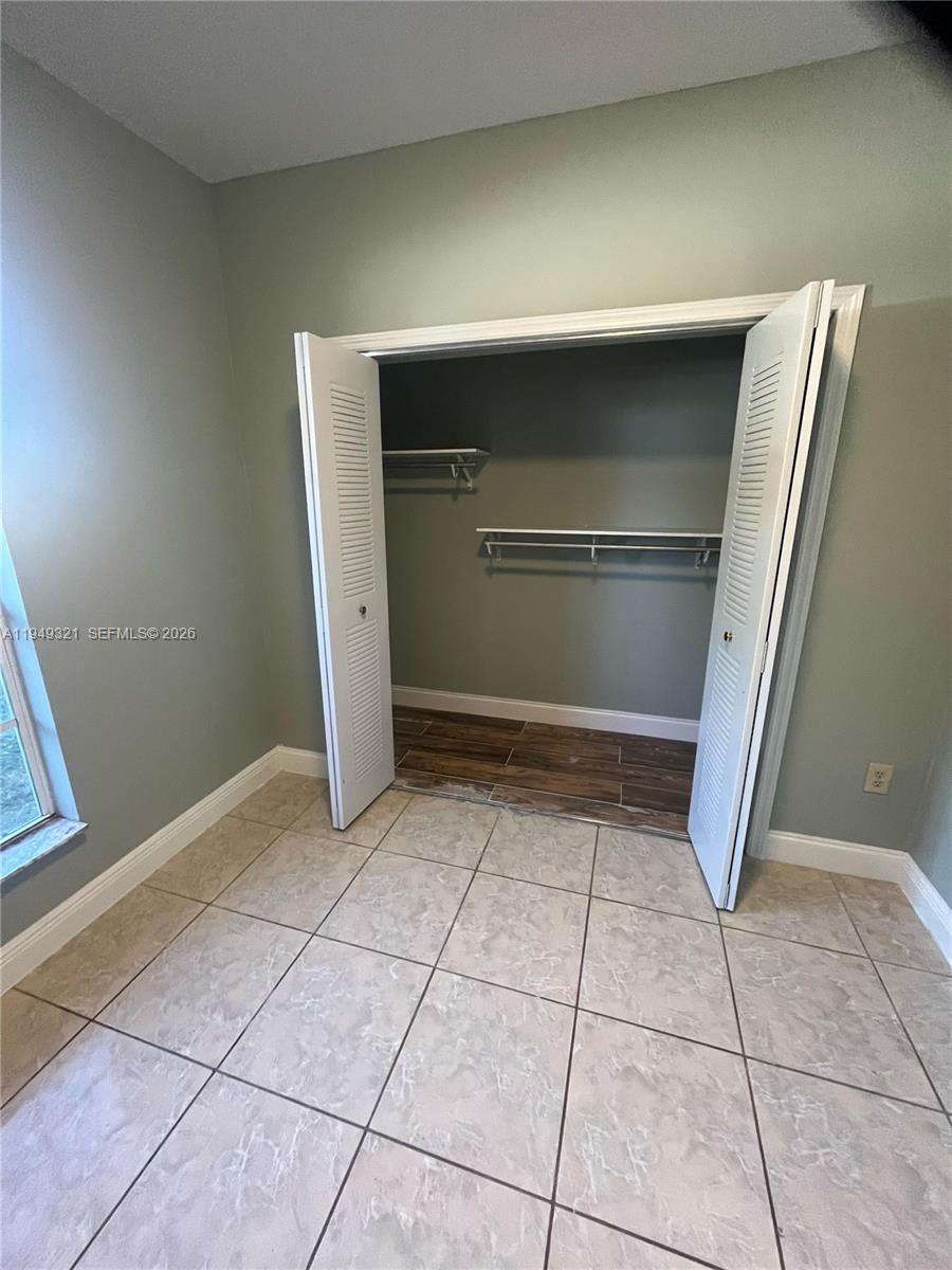 603 Northwest 97th Street, Unit 603 Miami, FL 33150 - Photo 22 of 28 a kitchen with a stove and a refrigerator