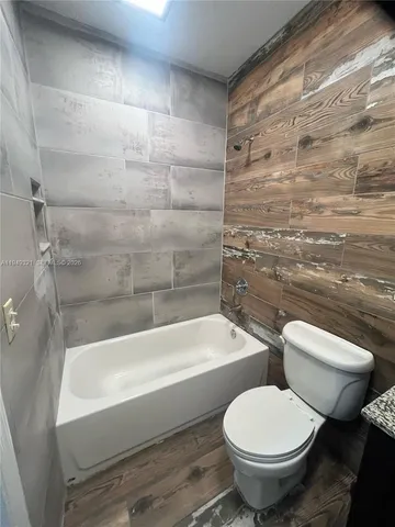 a bathroom with a toilet and a mirror