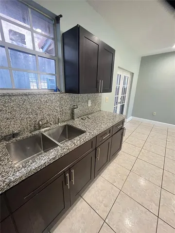 a kitchen with a sink a counter top space and cabinets