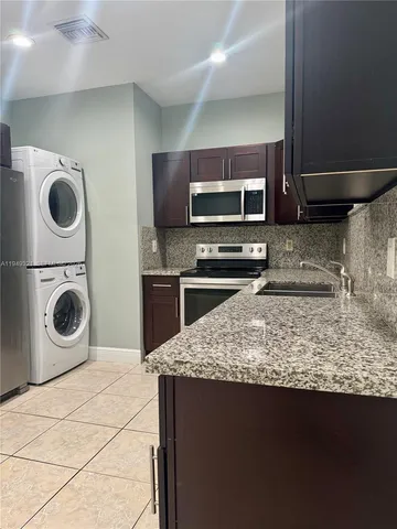 a kitchen with a stove sink and microwave