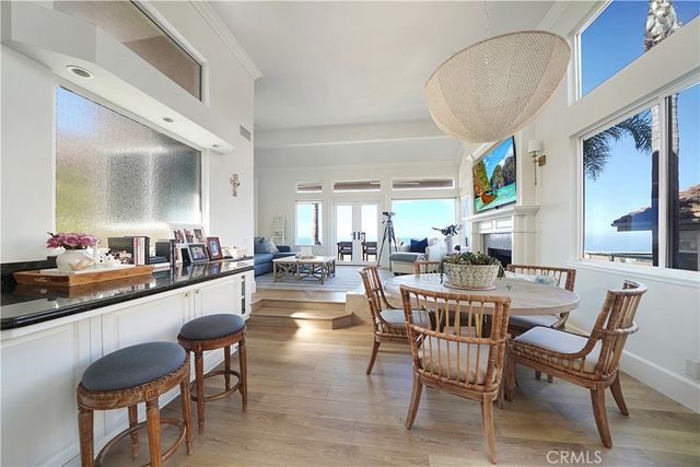 a dining hall with stainless steel appliances kitchen island granite countertop a dining table and chairs