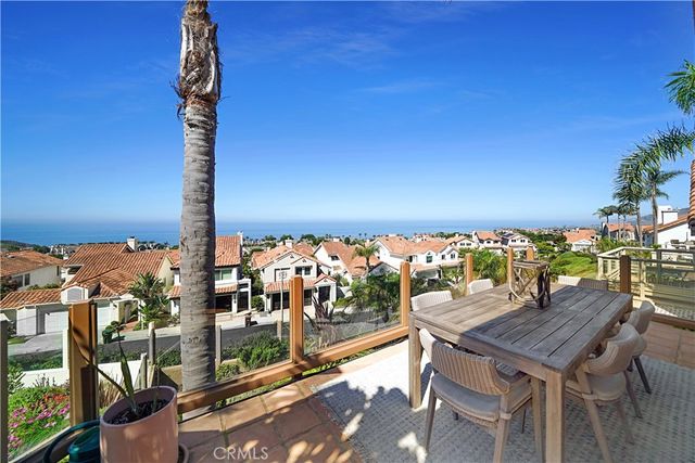 a view of a balcony with dining table and chairs with wooden floor
