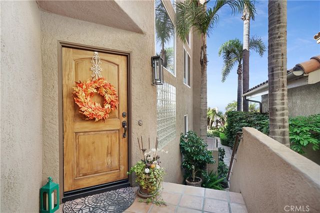 a couple of flower plants in front of a building