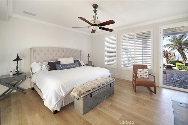 a bedroom with a bed a couch and a fireplace