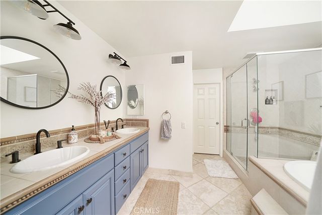 a spacious bathroom with a granite countertop sink and a mirror