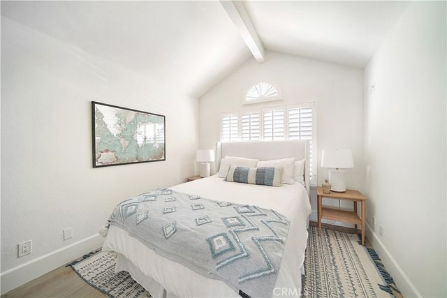 a bathroom with a granite countertop toilet a sink and a mirror