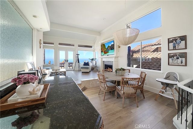 a living room with furniture fireplace and a large window