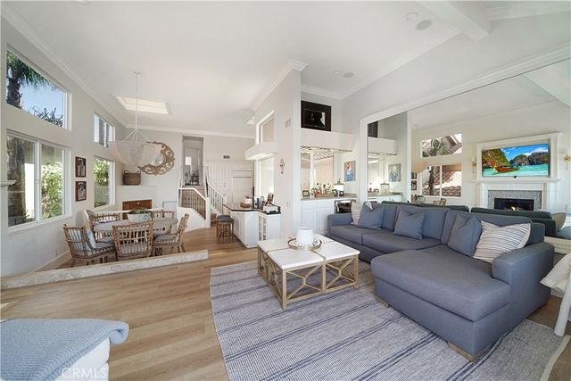 a living room with furniture and view of kitchen