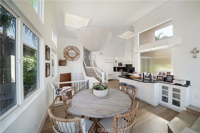 a kitchen with stainless steel appliances a table and chairs