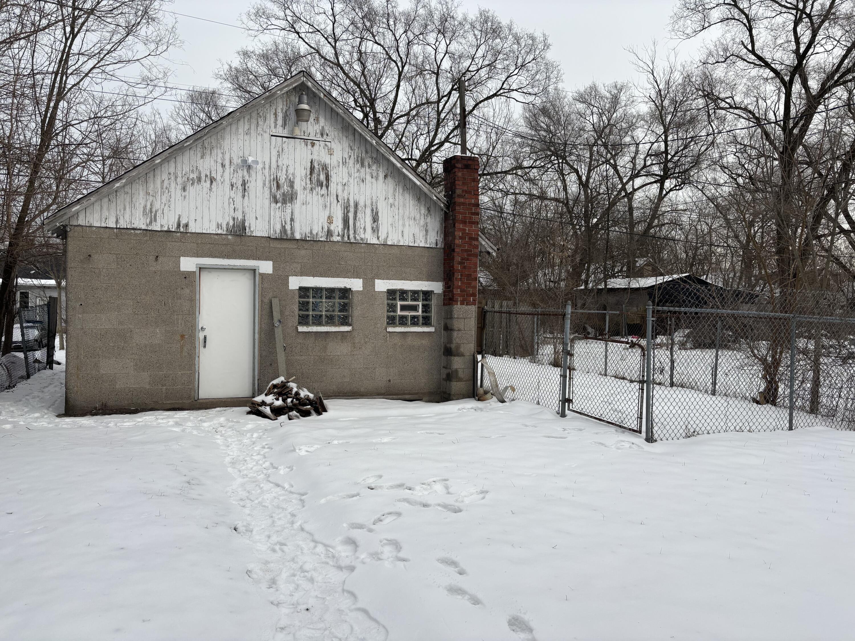 3953 Monroe Street Gary, IN 46408 - Photo 12 of 13 a view of a house with a wooden fence and a bench