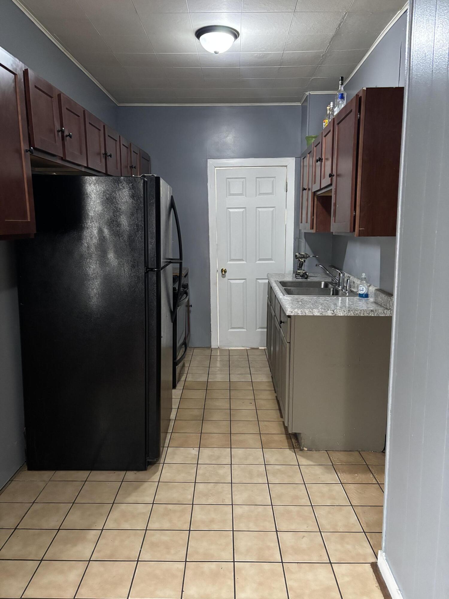 3953 Monroe Street Gary, IN 46408 - Photo 5 of 13 a kitchen with stainless steel appliances granite countertop a refrigerator and a stove