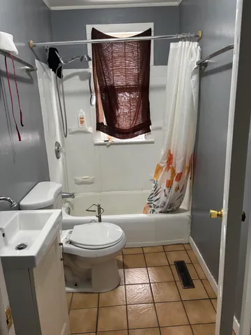 a bathroom with a sink toilet and a mirror