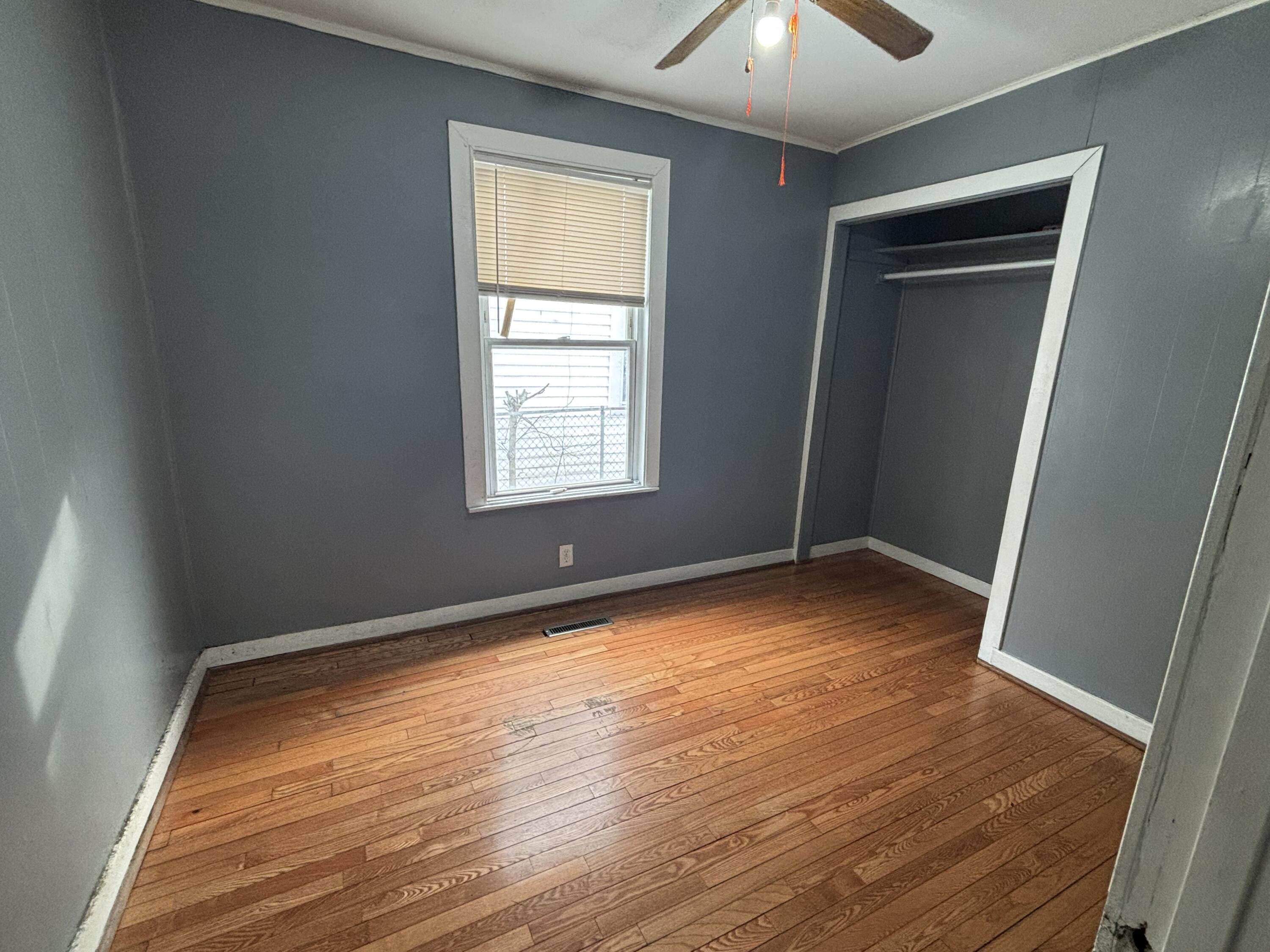 3953 Monroe Street Gary, IN 46408 - Photo 9 of 13 a view of an empty room with wooden floor and a window
