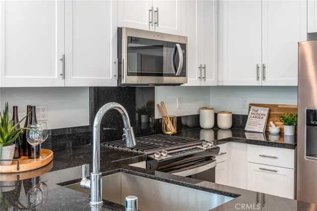 a kitchen with a stove and a white cabinets