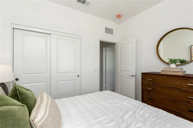 a bedroom with a bed and a mirror