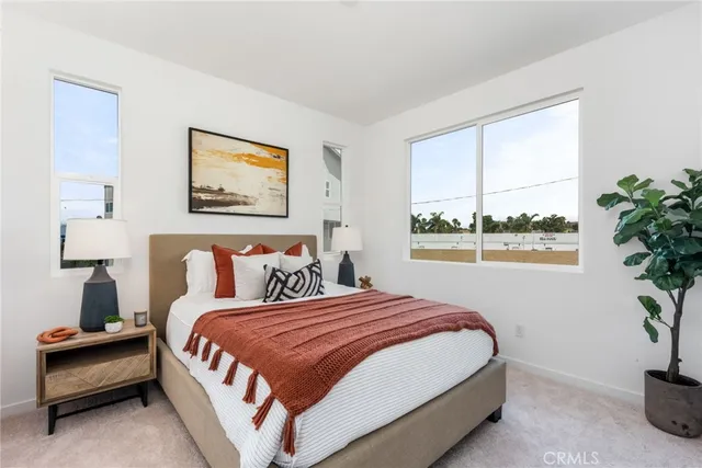 a bedroom with bed and a potted plant