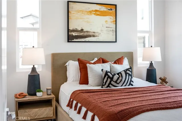 a bedroom with a bed and painting on the wall