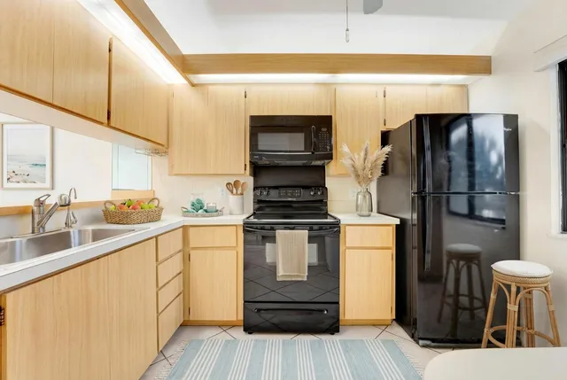 a kitchen with appliances cabinets and a sink
