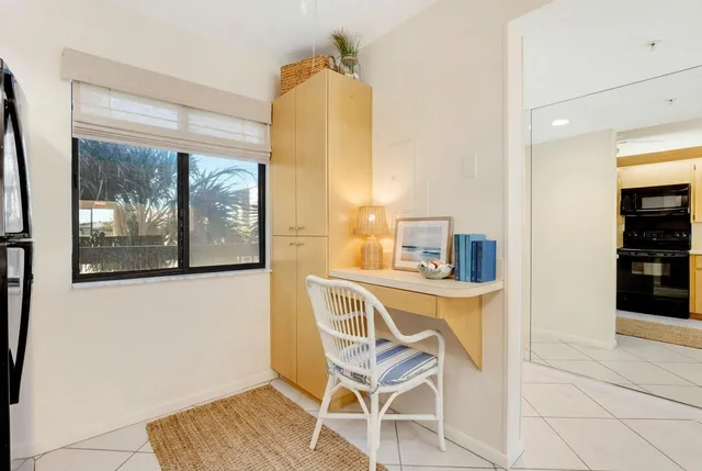 a view of a dining room with furniture and a window
