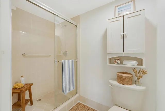 a bathroom with a shower a toilet and sink