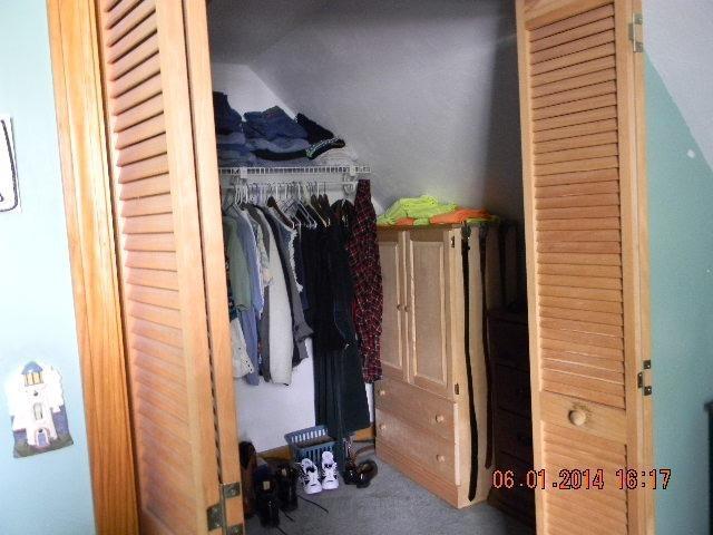 63 Degrass Road Mashpee, MA 02649 - Photo 8 of 22 a view of walk in closet with clothes and shoes