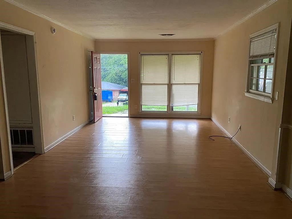 770 Andrea Drive Columbus, GA 31907 - Photo 3 of 5 a view of an empty room with wooden floor and a window