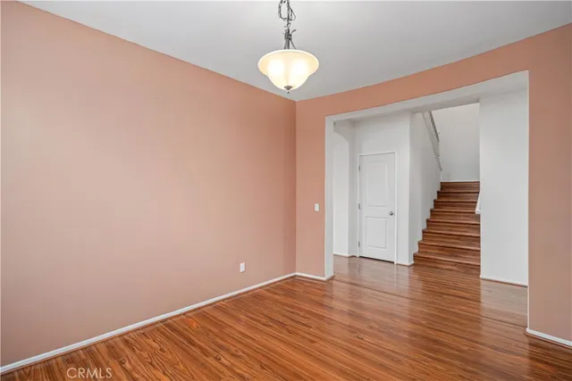 a view of a room with wooden floor and staircase