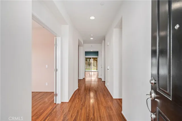 a view of hallway with wooden floor