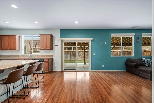 a kitchen with cabinets and wooden floor