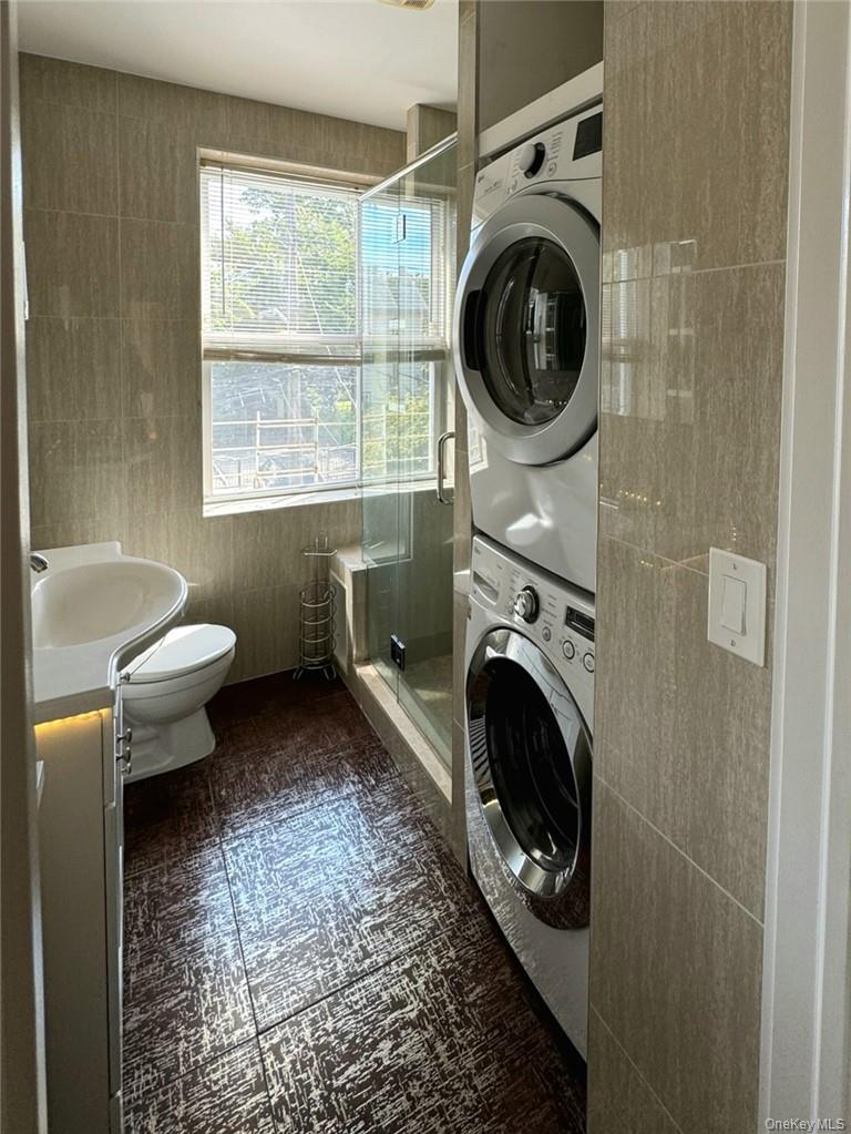 43 McGeory Avenue, Unit 2 Bronxville, NY 10708 - Photo 9 of 11 Bathroom with stacked washer / dryer