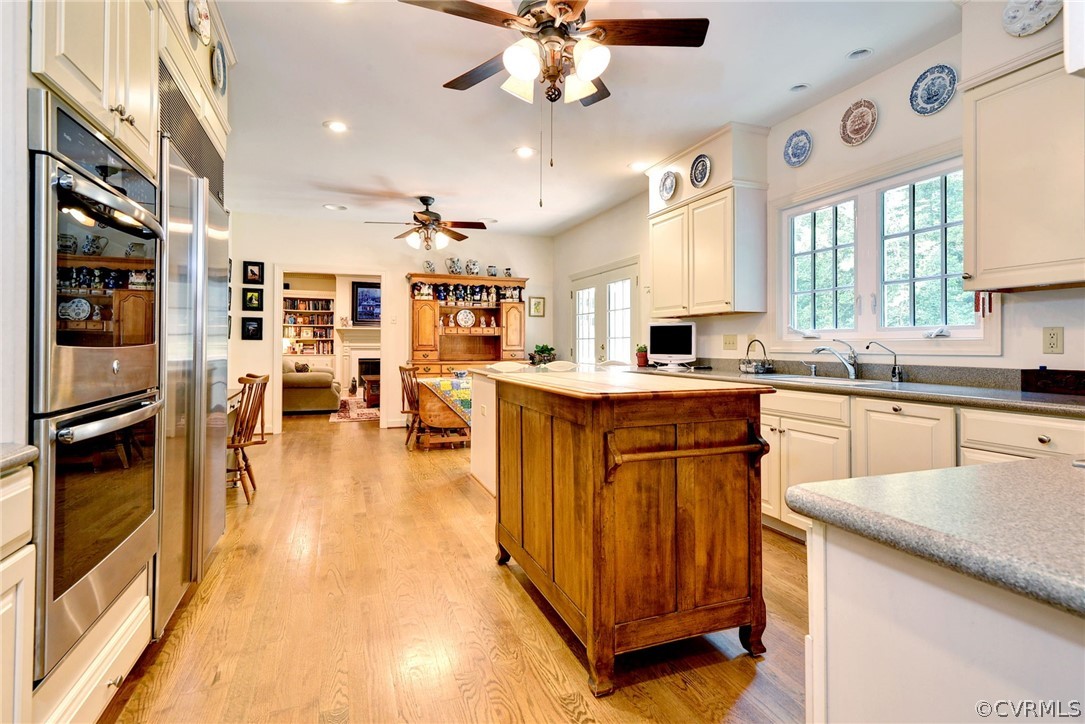 105 Mid Ocean Williamsburg, VA 23188 - Photo 12 of 36 a kitchen with stainless steel appliances granite countertop a lot of counter space and wooden floors