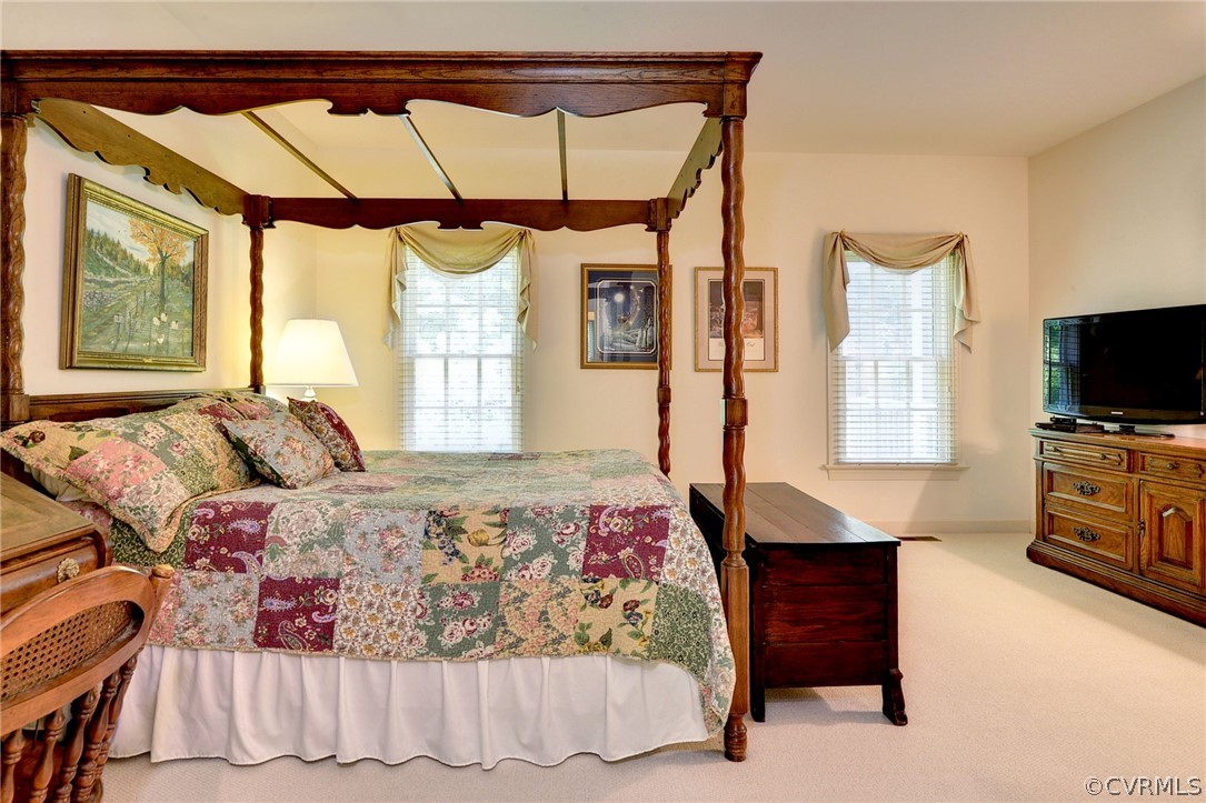 105 Mid Ocean Williamsburg, VA 23188 - Photo 18 of 36 a bedroom with a bed and a flat tv screen on the dresser