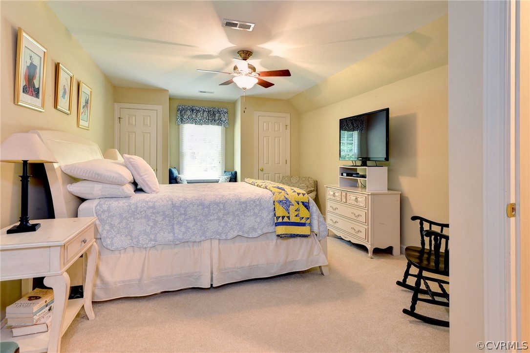 105 Mid Ocean Williamsburg, VA 23188 - Photo 23 of 36 a spacious bedroom with a bed and a chandelier