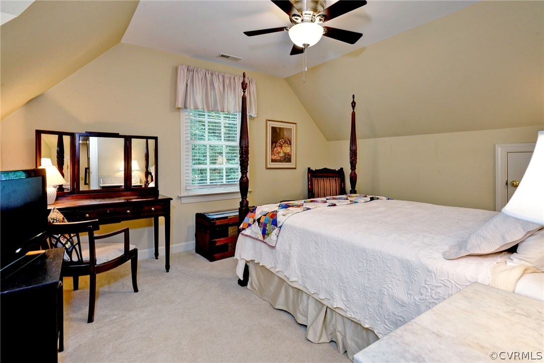 105 Mid Ocean Williamsburg, VA 23188 - Photo 26 of 36 a bedroom with a bed and a chandelier
