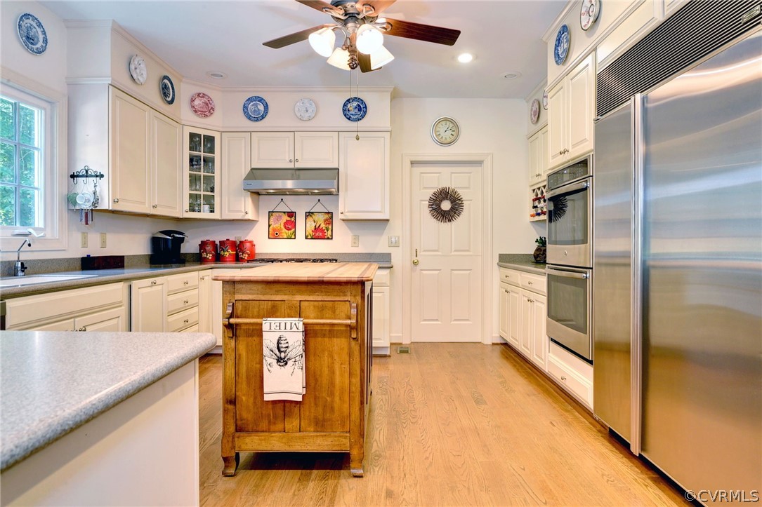 105 Mid Ocean Williamsburg, VA 23188 - Photo 10 of 36 a kitchen with granite countertop stainless steel appliances a stove cabinets and a window