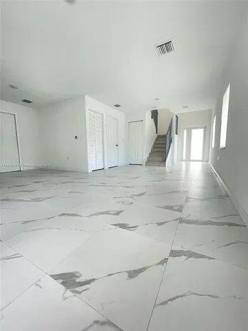 a kitchen with a sink a microwave and refrigerator