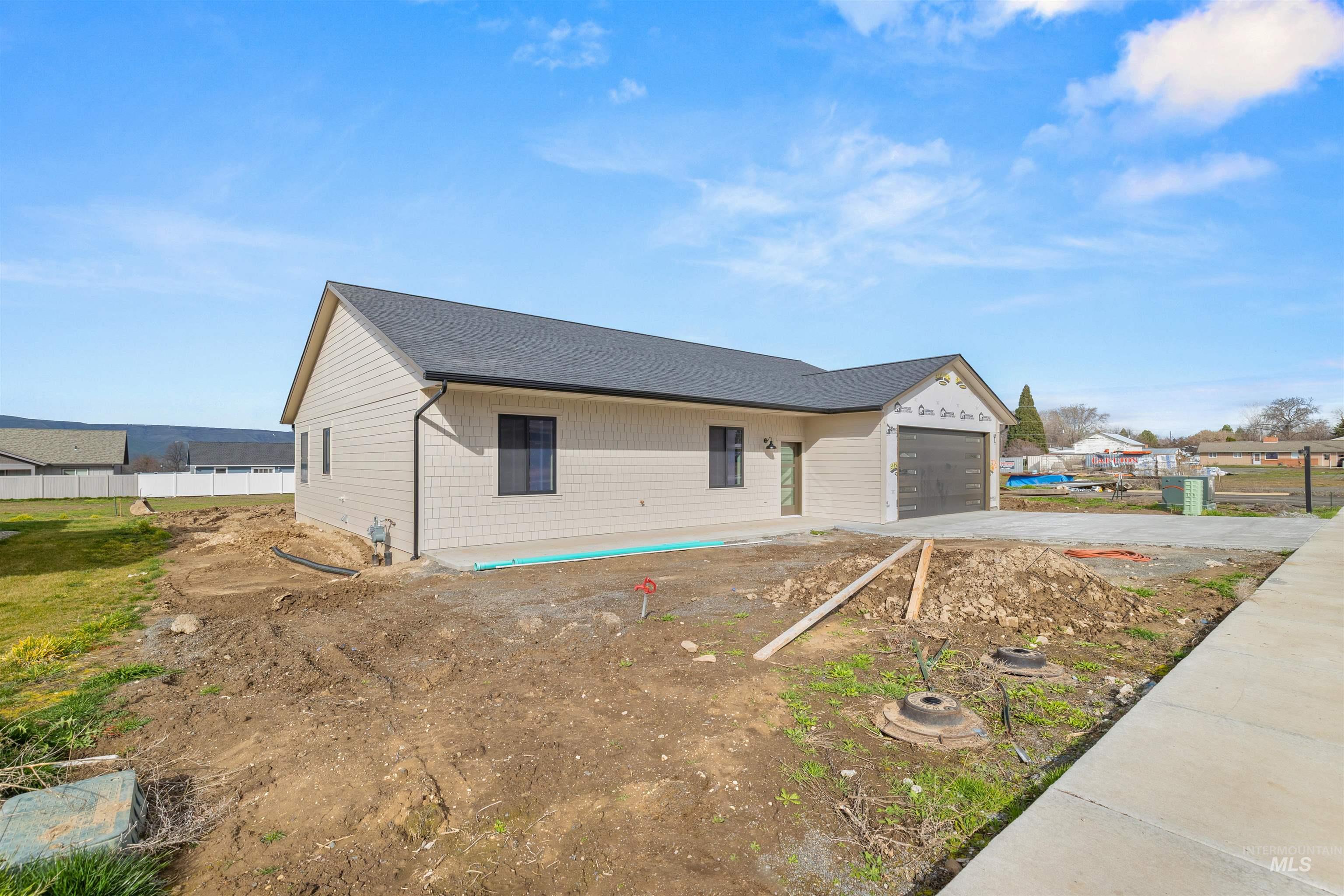 335 Warner Avenue Lewiston, ID 83501 - Photo 43 of 43 View of front of house featuring concrete driveway, roof with shingles, and an attached garage