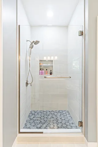 a white toilet sitting next to a shower