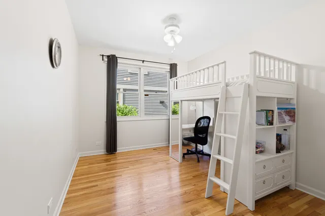 a bathroom with a bathtub shower sink vanity mirror and toilet