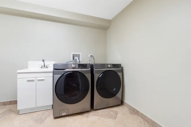 a view of a chair and table in the backyard