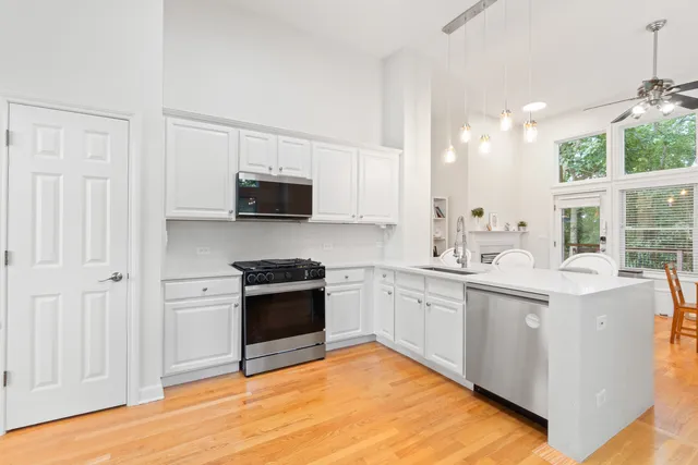 a kitchen with granite countertop a stove top oven sink and cabinets