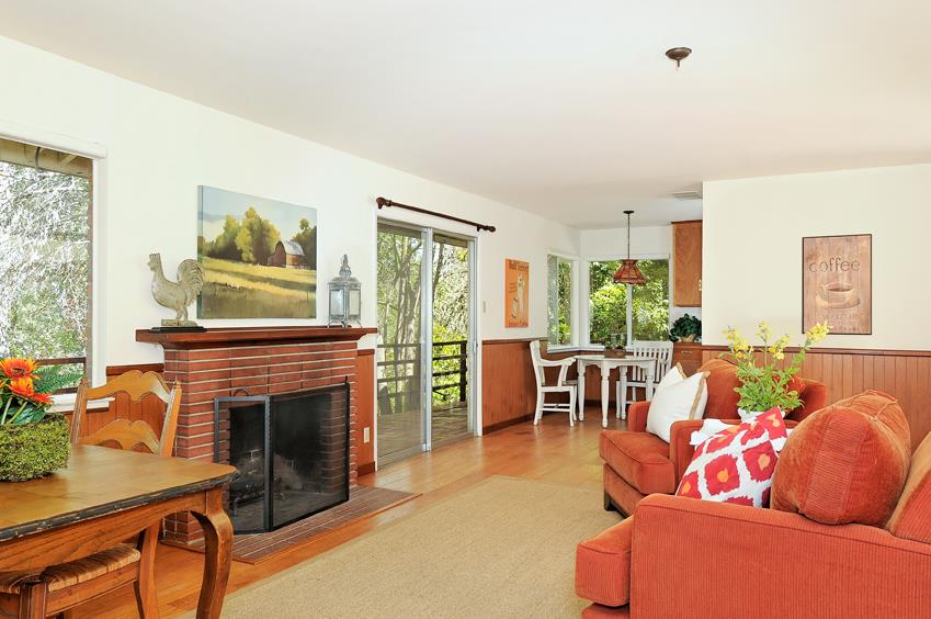 2915 Woodside Road Woodside, CA 94062 - Photo 5 of 17 a living room with furniture a flat screen tv and a fireplace