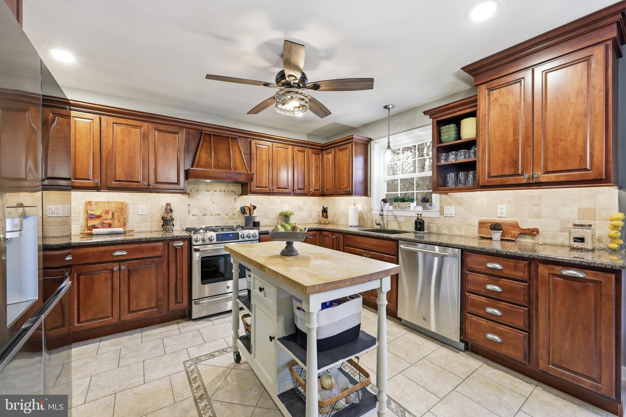 4 Prosit Lane Ocean View, NJ 08230 - Photo 13 of 29 a kitchen with granite countertop a sink cabinets stainless steel appliances and a window