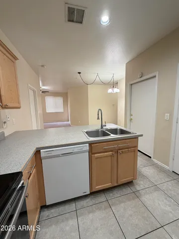 a kitchen with stainless steel appliances granite countertop a sink and a stove