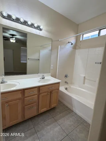 a spacious bathroom with a tub sink and mirror