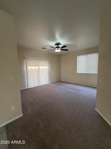 a view of a room with a ceiling fan