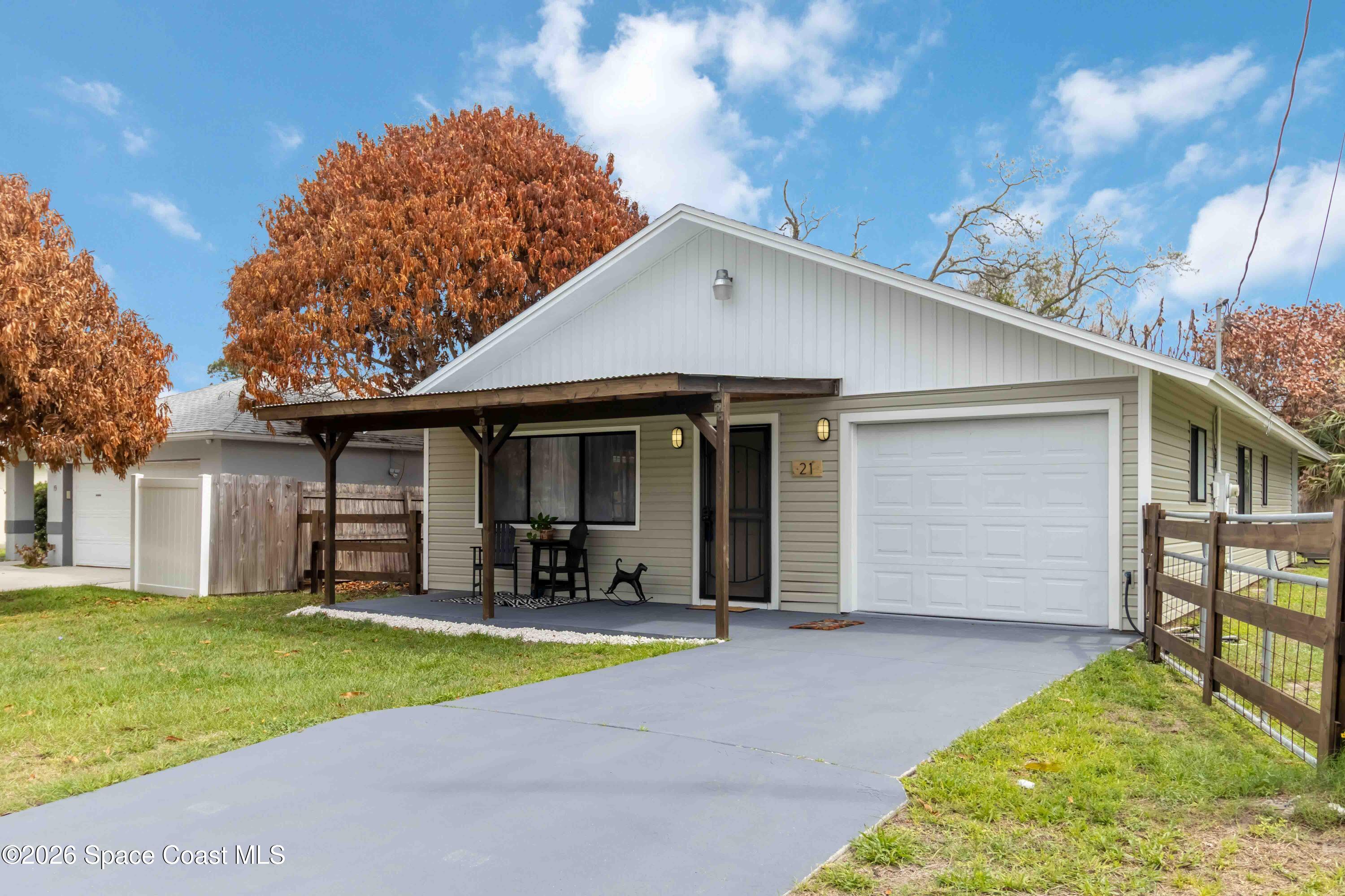21 Branch Street Melbourne, FL 32901 - Photo 1 of 30 a front view of a house with a yard and garage