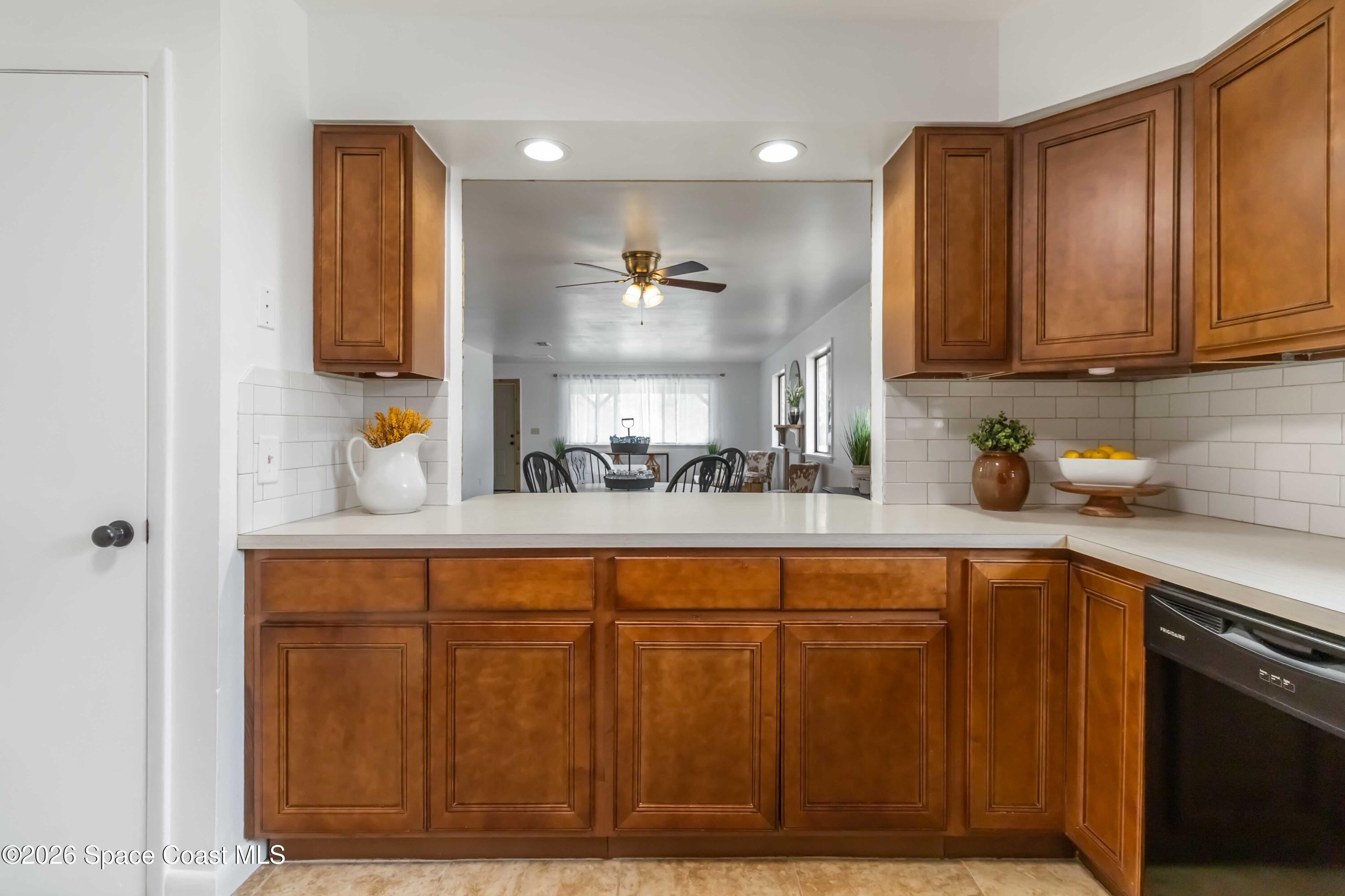 21 Branch Street Melbourne, FL 32901 - Photo 11 of 30 a kitchen with wooden cabinets and a sink