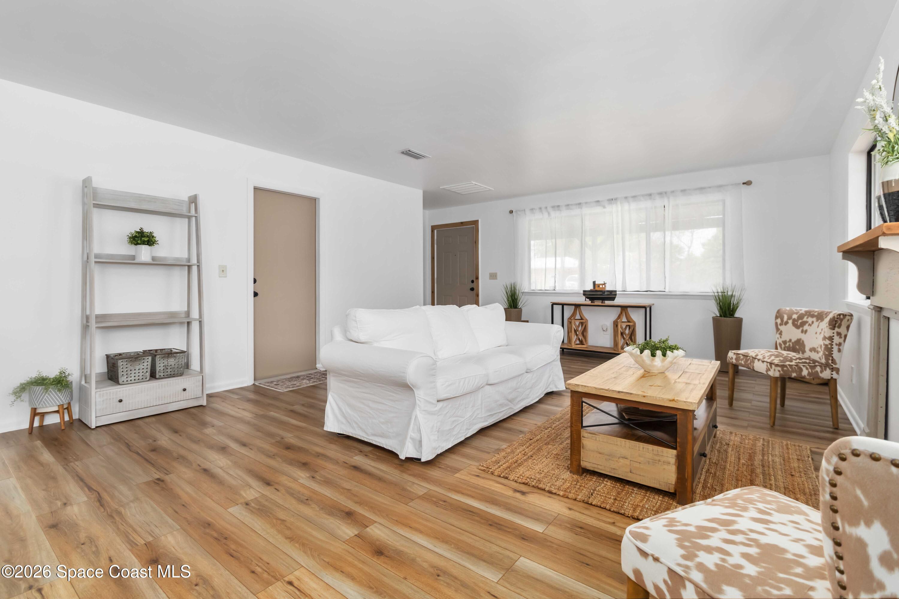 21 Branch Street Melbourne, FL 32901 - Photo 18 of 30 a living room with furniture and a wooden floor